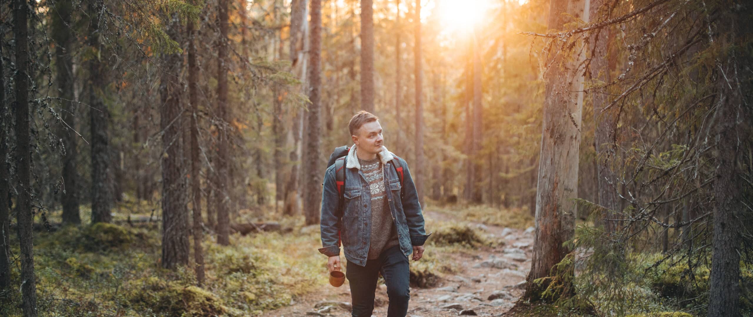 Man walking in forest in Finnish National Park called Pyhä-Häkki