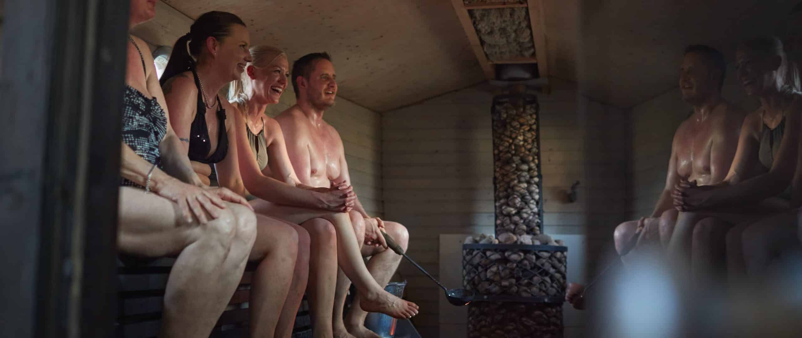 Happy people in sauna in Finland