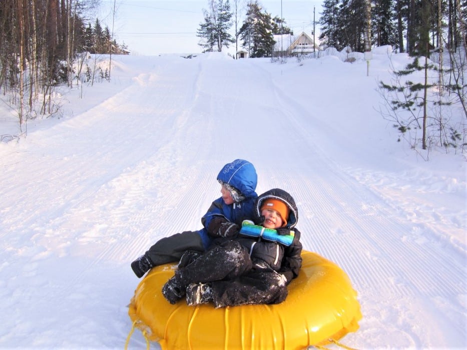 children at sledding hill in Finland